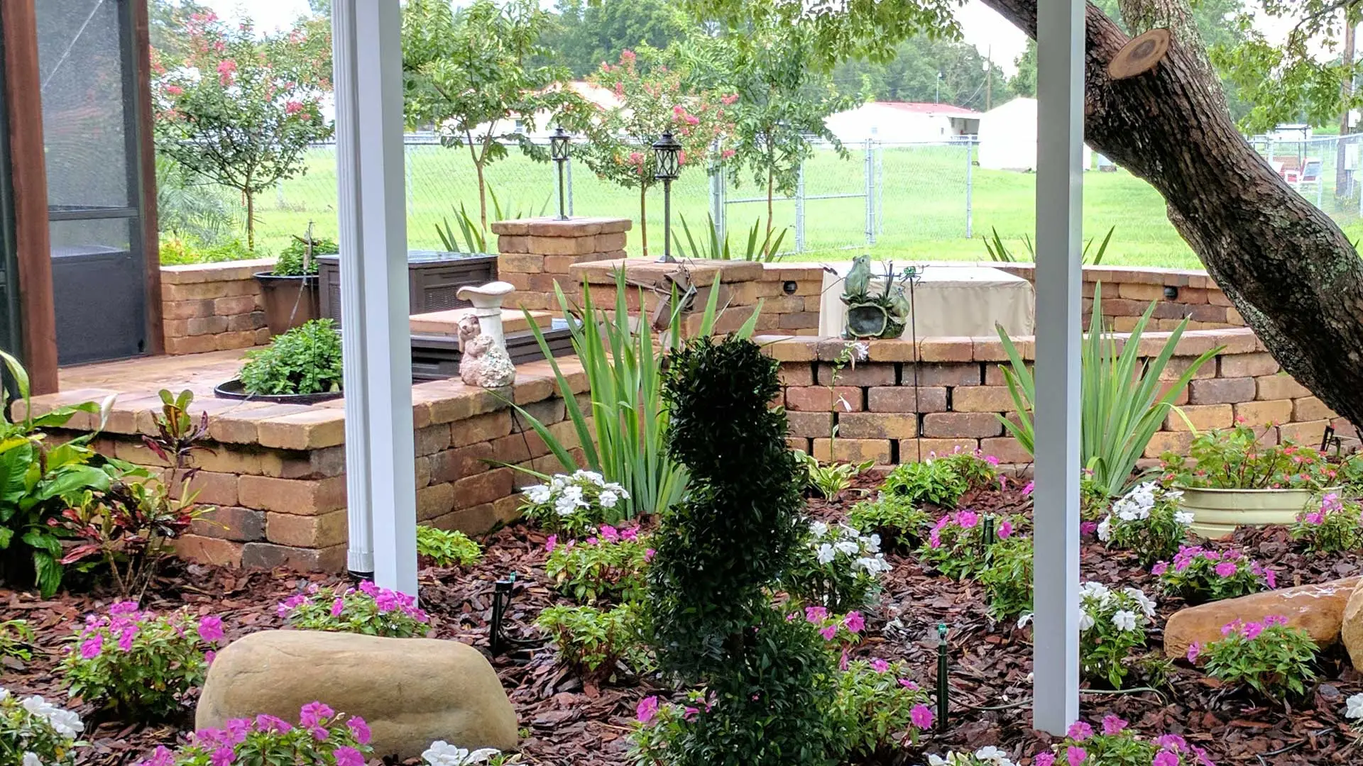 New patio pavers, hardscaped seating wall and landscaping at a home in Lakeland, FL.