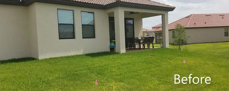 Backyard of a home prior to a hardscape design and installation at a home in Lakeland, FL.